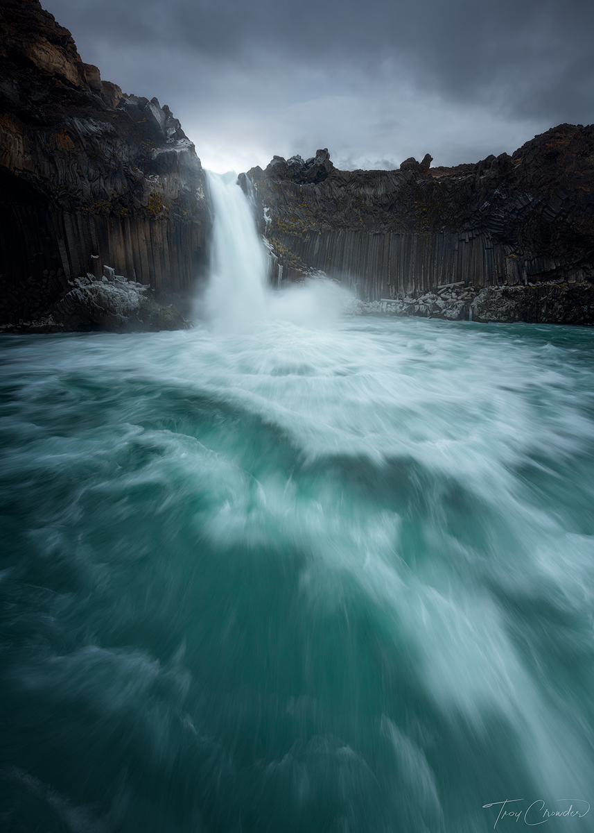 A beautiful combination of deep aqua glacier water with jagged basalt columns at Aldeyjarfoss in Northern Iceland.